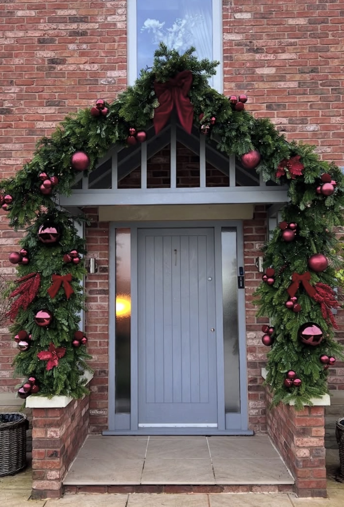 Large Christmas garland framing a covered entrance