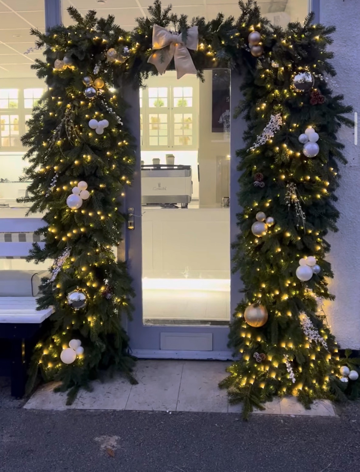Illuminated Christmas garland around a commercial doorway